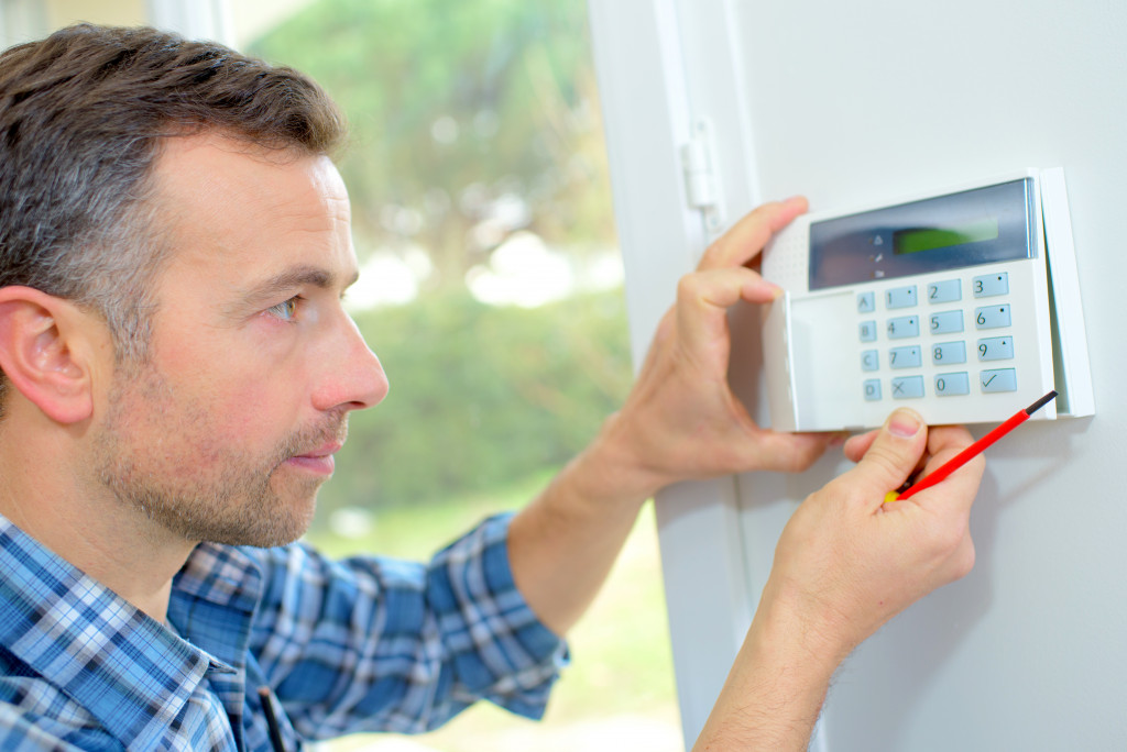 homeowner installing home security device