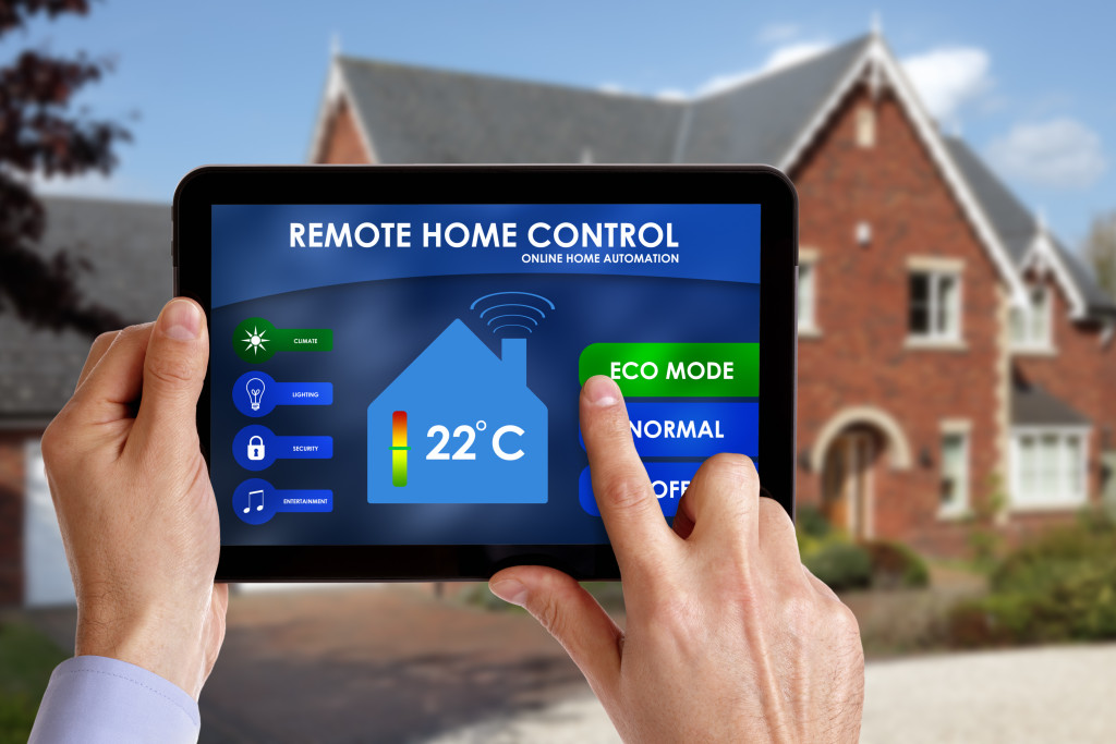 Someone holding a tablet with controls for their smart home